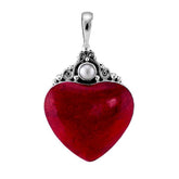 Handcrafted sterling silver heart pendant with vibrant red coral centerpiece and luminous Mother of Pearl accent, artisan Bali jewelry for timeless elegance.